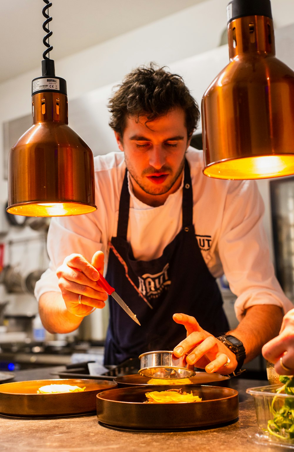 Chef confidently preparing food in a busy kitchen